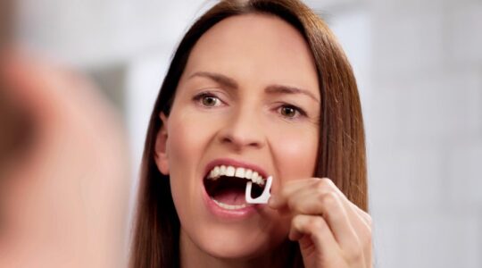 Woman flossing. | Newsreel