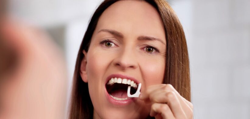 Woman flossing. | Newsreel