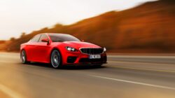 Red car on road. | Newsreel