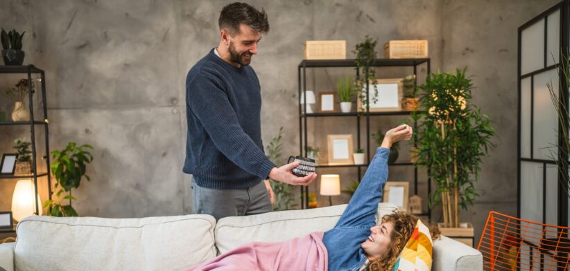 Man bringing coffee to waking woman.