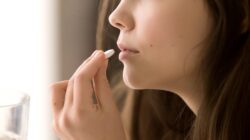 Woman taking pill. | Newsreel