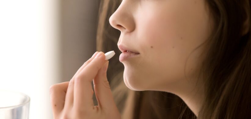 Woman taking pill. | Newsreel