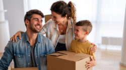 Moving, parents and child in new home bonding together, unpacking boxes for family time