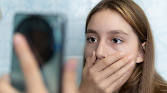 Young girl shocked watching phone. | Newsreel