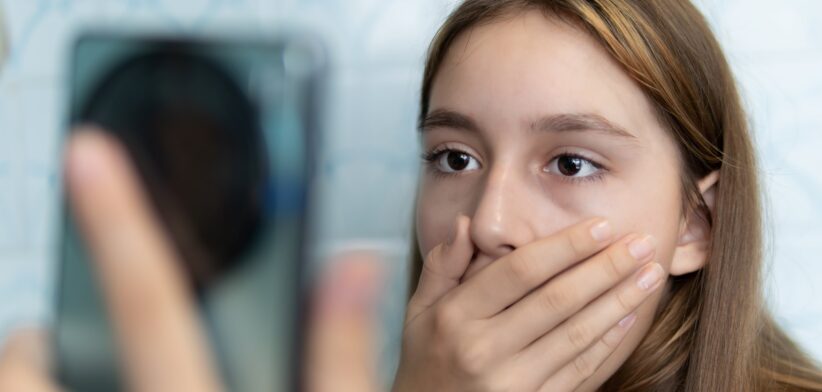 Young girl shocked watching phone. | Newsreel