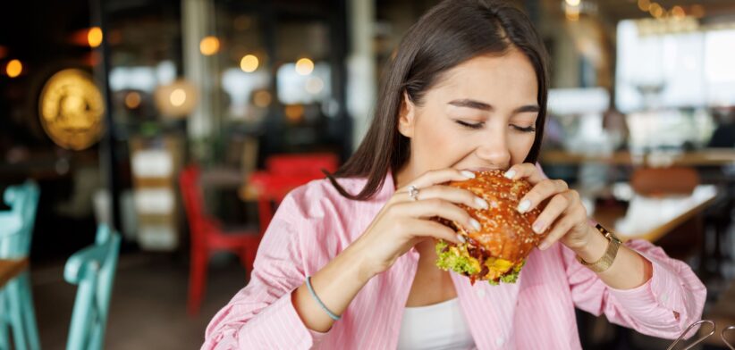 Woman eating a burger. | Newsreel