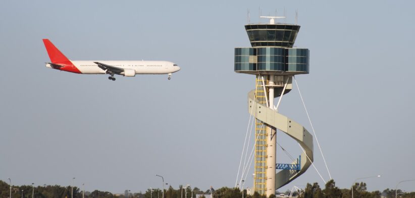 Air traffic control tower and plane