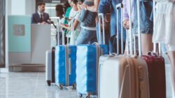 Passengers in airport queue. | Newsreel