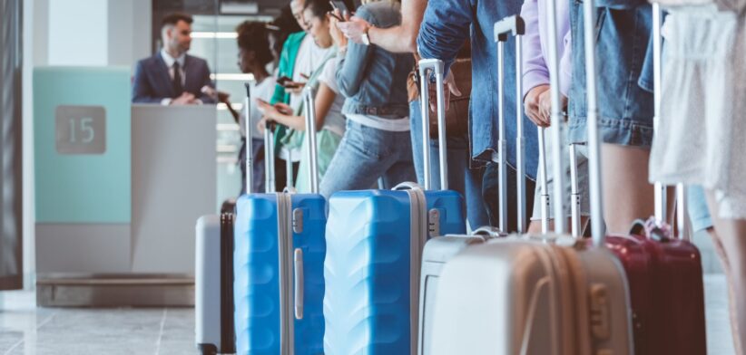 Passengers in airport queue. | Newsreel