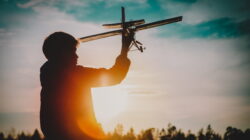 boy play with toy play in sunset nature