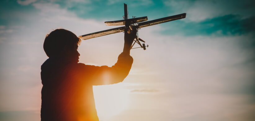 boy play with toy play in sunset nature
