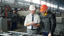 Manager and worker on production floor.