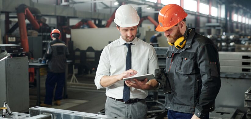 Manager and worker on production floor.