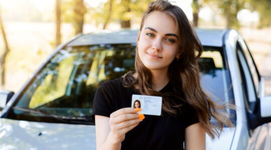 Young woman with drivers licence.
