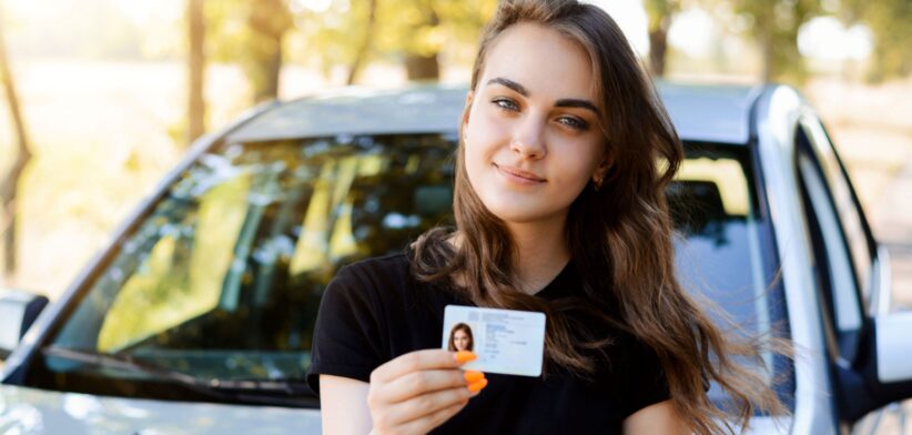 Young woman with drivers licence.