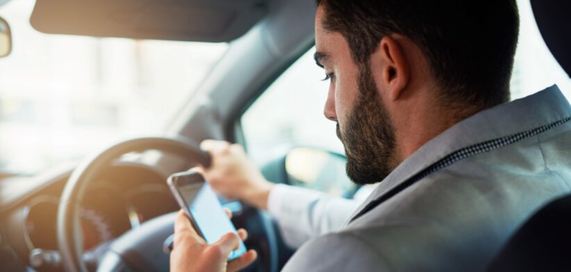 Driver using mobile phone while driving.