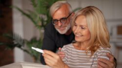 Mature couple looking at pregnancy test. | Newsreel