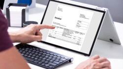 Man looking at invoice on computer. | Newsreel