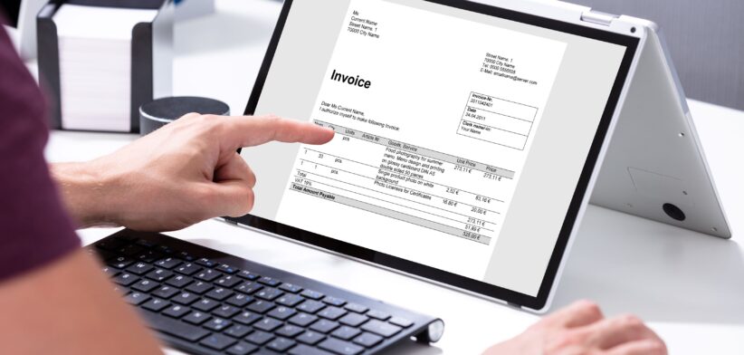 Man looking at invoice on computer. | Newsreel