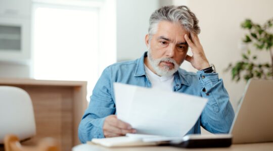 Man looking at statement. | Newsreel