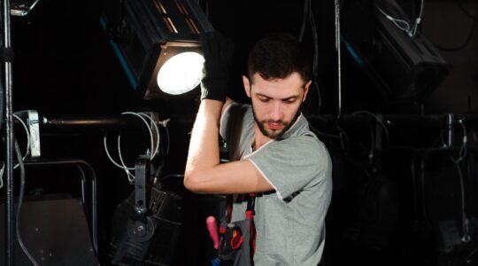 Theatre lighting technician. | Newsreel