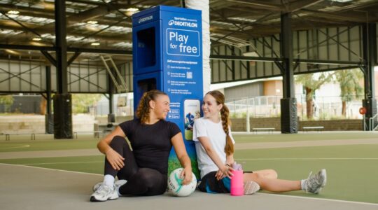 Girls in front of sports locker. | Newsreel