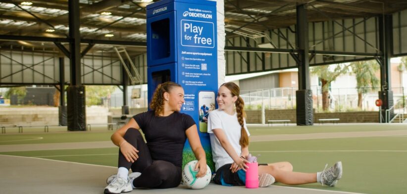 Girls in front of sports locker. | Newsreel