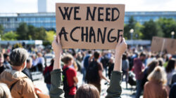 Rear view of people with placards and posters on global strike for climate change.