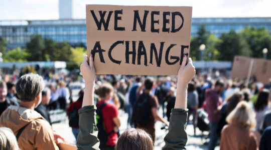 Rear view of people with placards and posters on global strike for climate change.