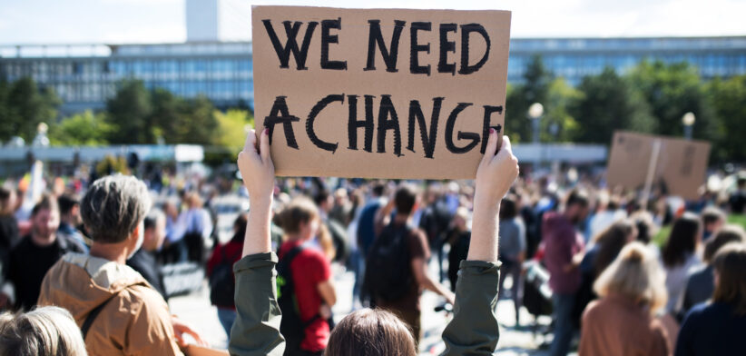 Rear view of people with placards and posters on global strike for climate change.