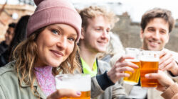 Friends drinking and toasting with beer at pub