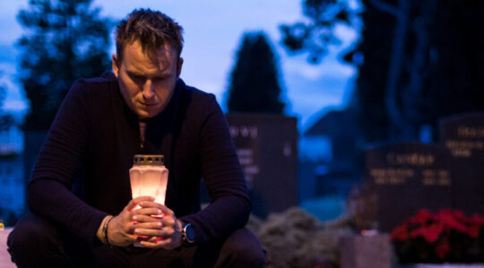 Lighting candles by the grave