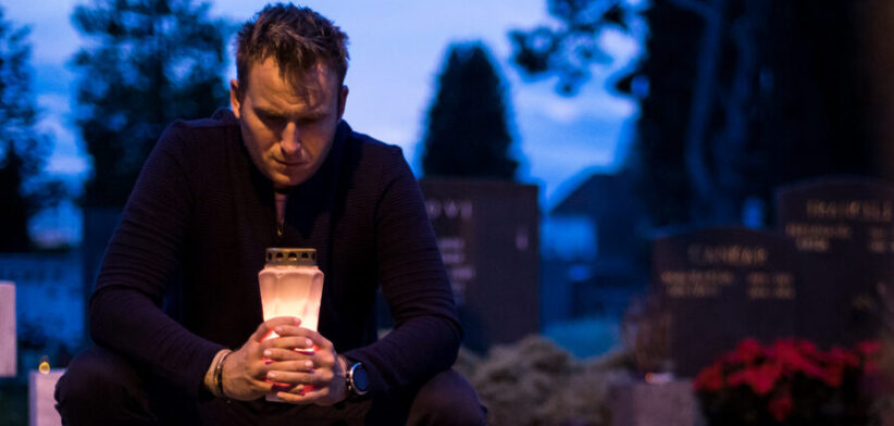 Lighting candles by the grave