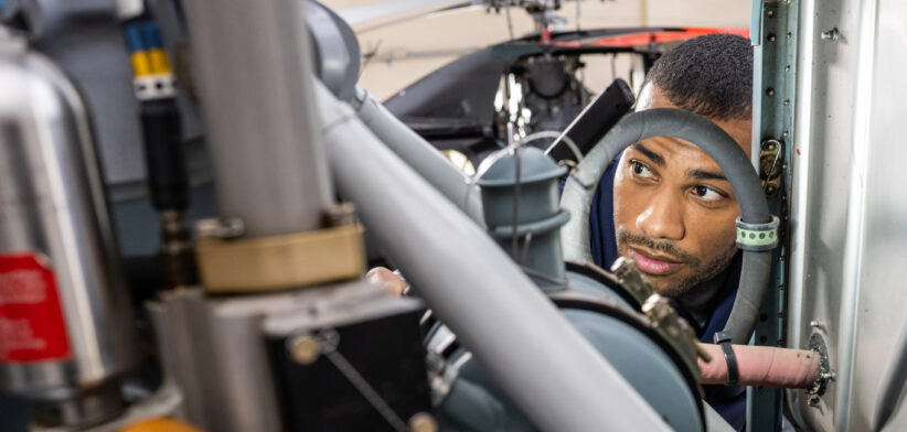 Air vehicle maintenance technician fixing jet, close view
