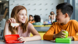 Joyful multicultural classroom with children enjoying lunch