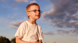 Boy sitting on hay bale