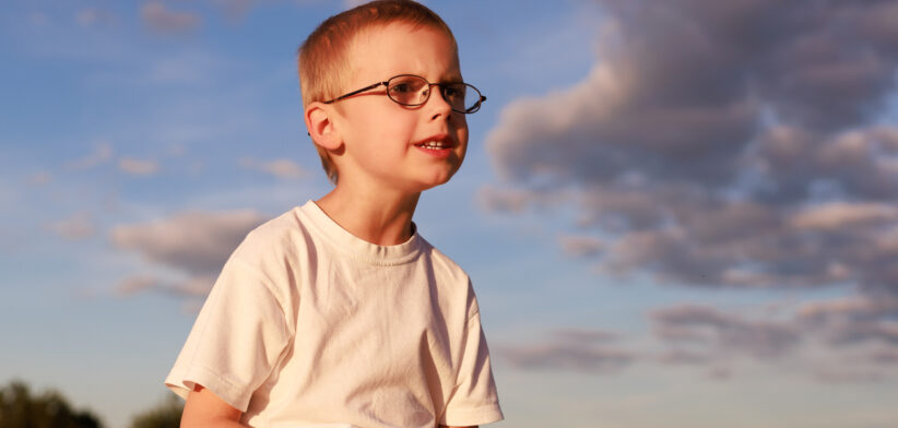 Boy sitting on hay bale