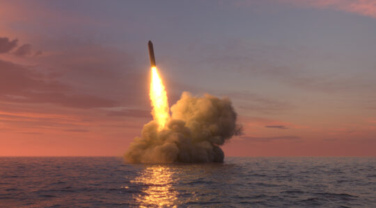 Ballistic missile launch from underwater at sunset