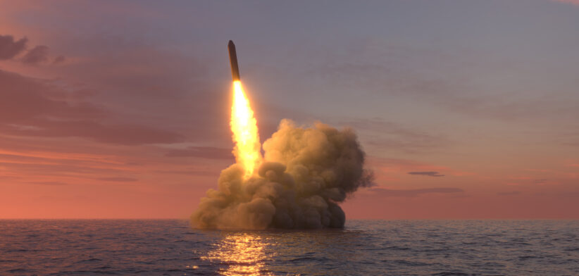 Ballistic missile launch from underwater at sunset
