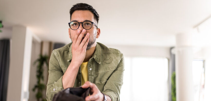 Serious young man having financial problems.