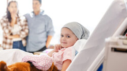 Young cancer patient in hospital bed