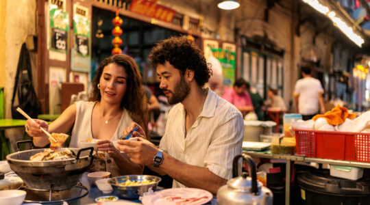 Couple enjoying a cozy hot pot dinner side by side