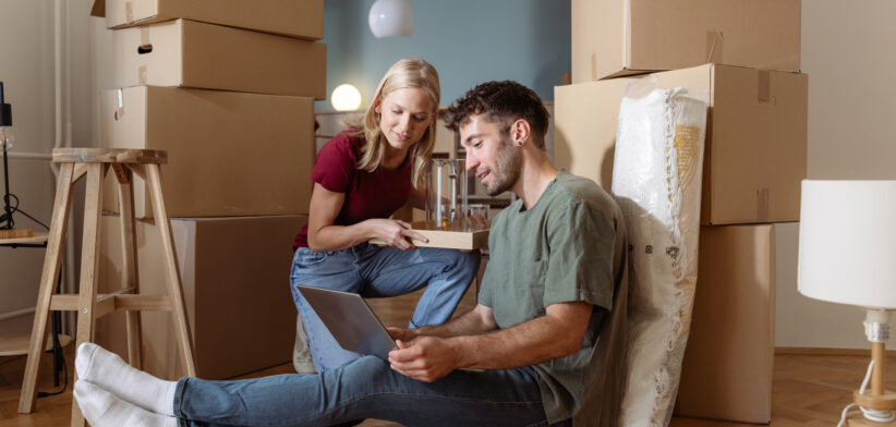 Young couple organizing their new home during a moving process