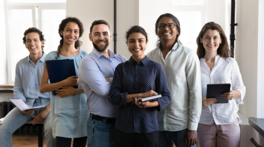 Multiethnic confident group of happy employees holding notebooks