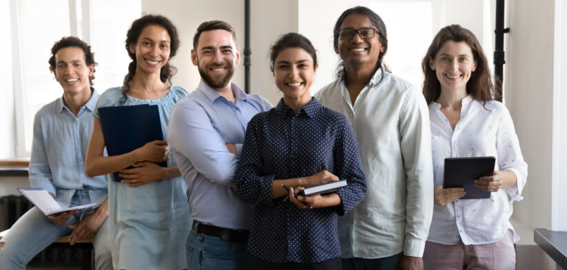 Multiethnic confident group of happy employees holding notebooks