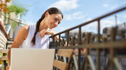 Working from home with a laptop at the balcony.