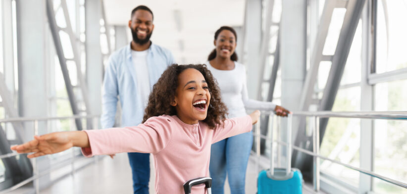 Happy family traveling with kid, standing in airport