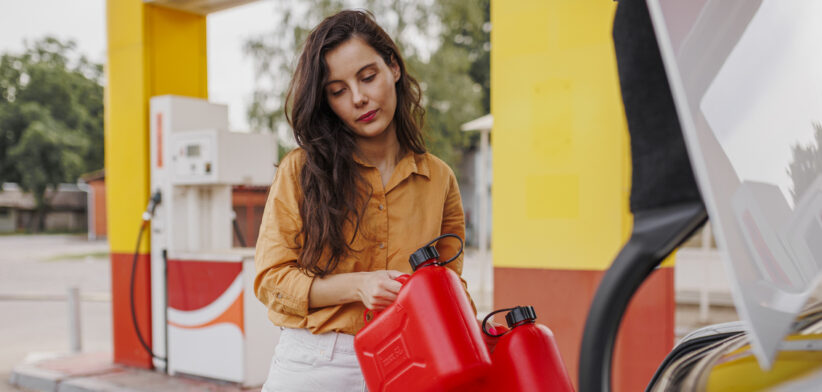 Anxiety woman with gas can on gas station