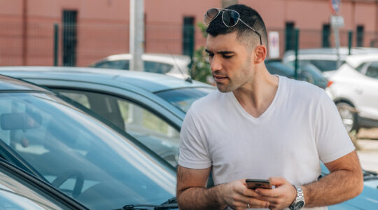 man buying used or second-hand car at dealership