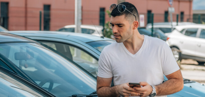 man buying used or second-hand car at dealership